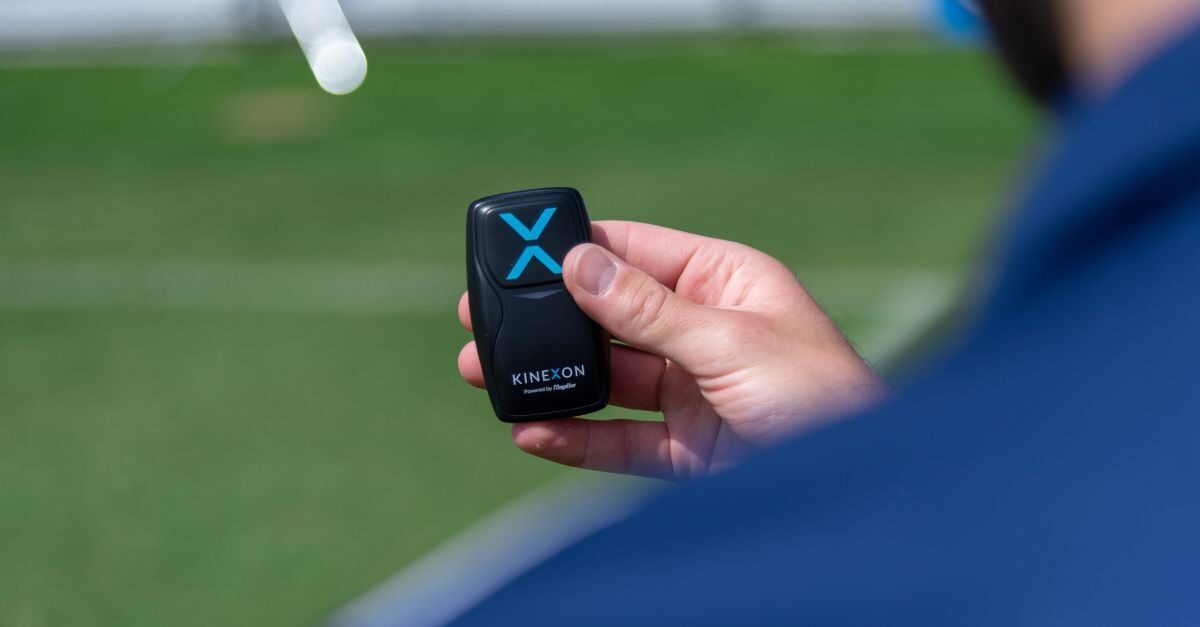 A sports scientist holds a player tracking sensor that is used to collect information on players like acceleration and deceleration and yardage.