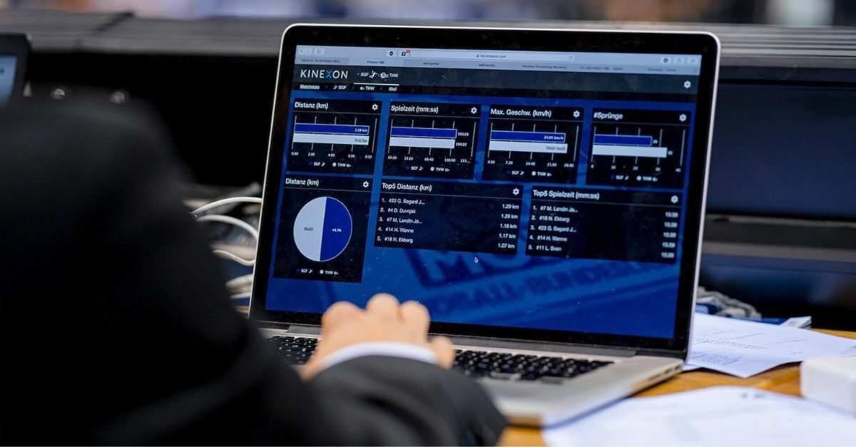 an handball analytics expert reviews the data coming in during a match and relays the information to coaches.