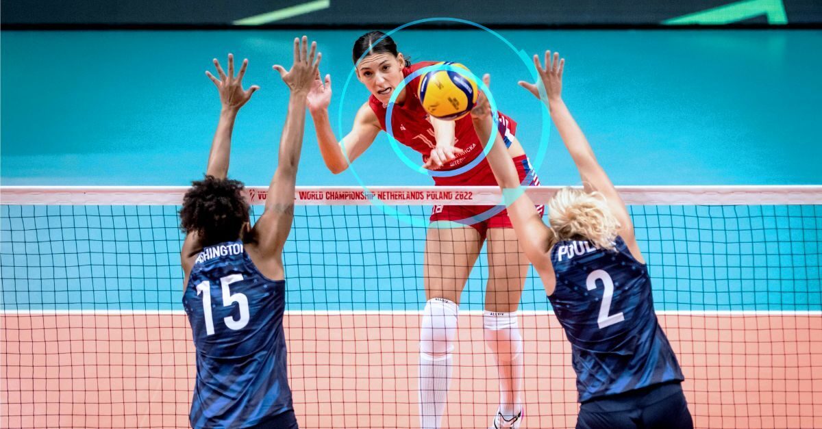 A women's volleyball player spikes the ball while a player tracking device keeps a record of how hard her body is working.