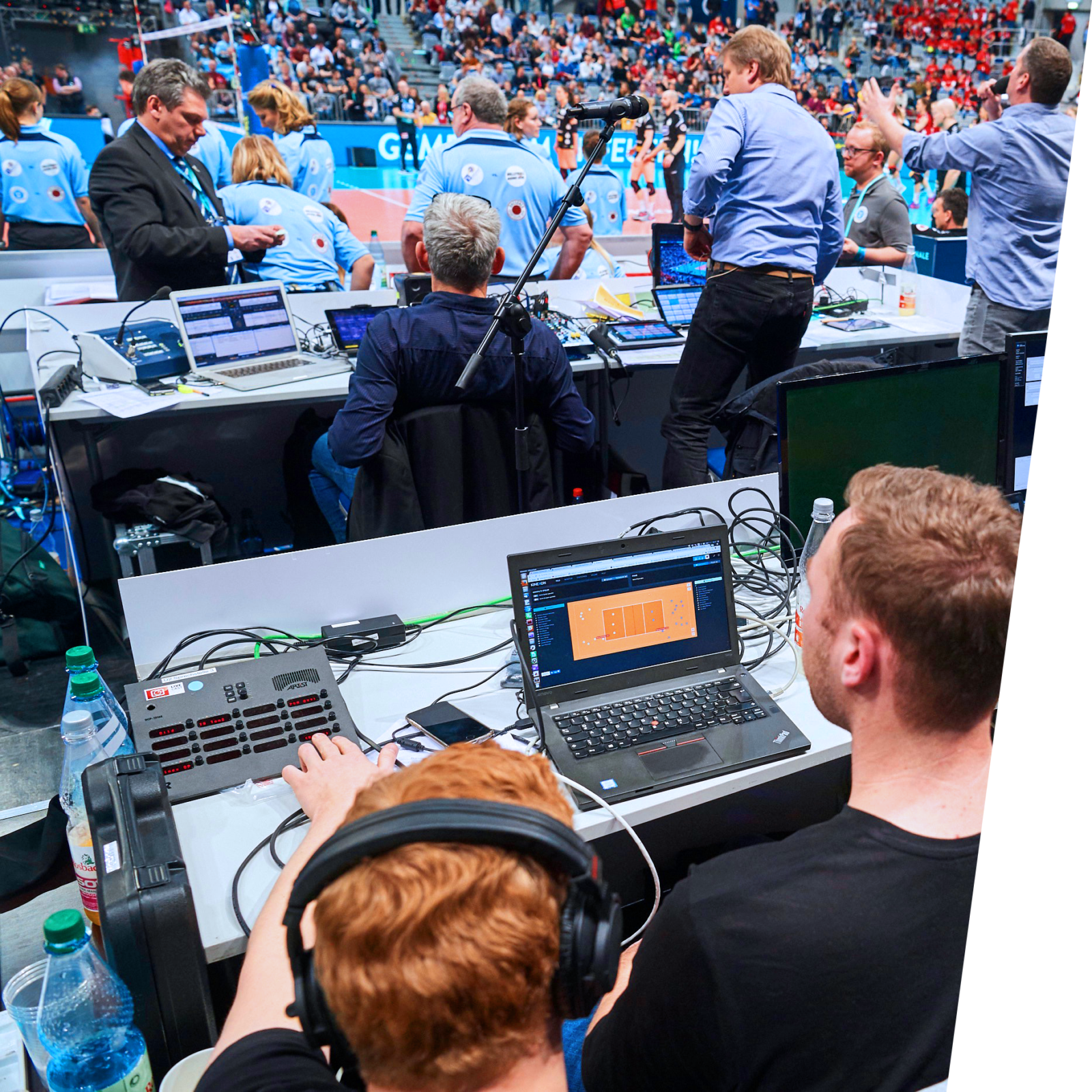 A sports data analyst sits courtside and provides stats to media members and scoreboard operators that they can share with fans in messages or social media posts.