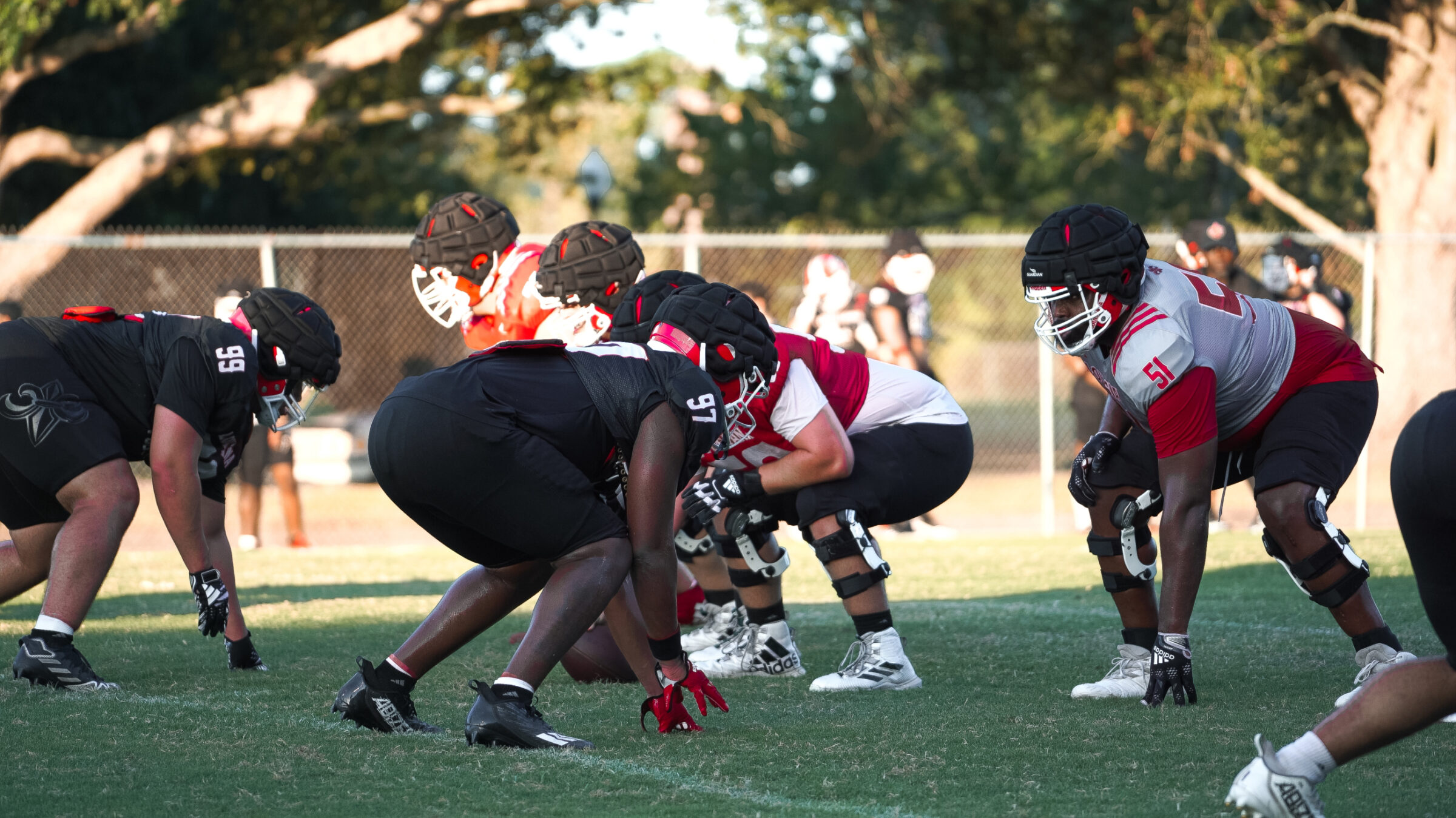 A quarterback is running for a first down, while his performance is being tracked by a sensor.