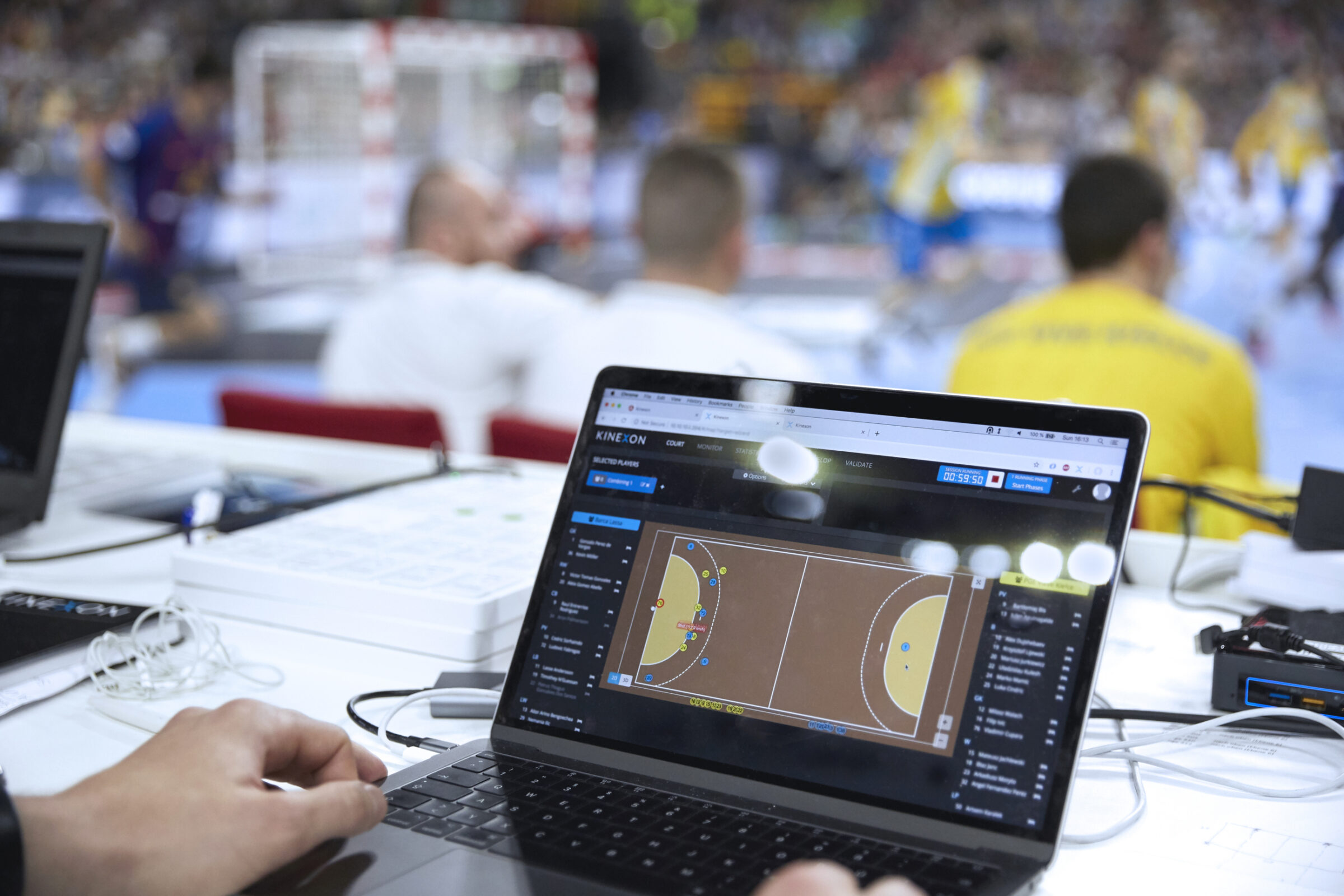 A coach follows the action of a team handball game on a computer screen to look for injury risks for his players.