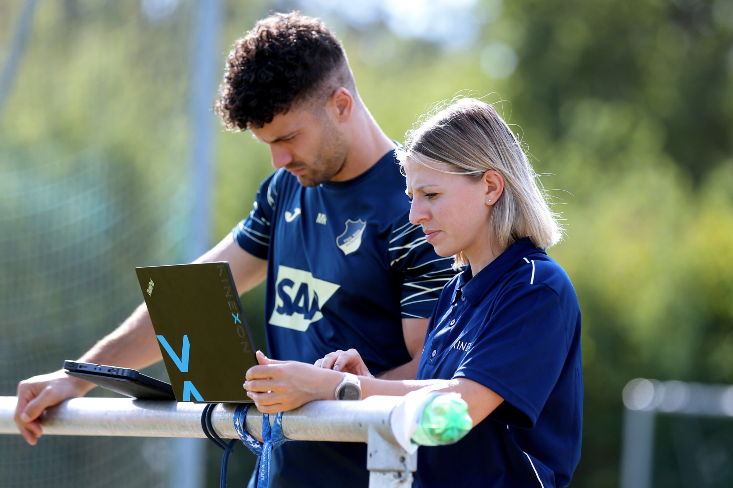 Sports scientists review the data collected during a female football training session that will be shared with the team's coach.