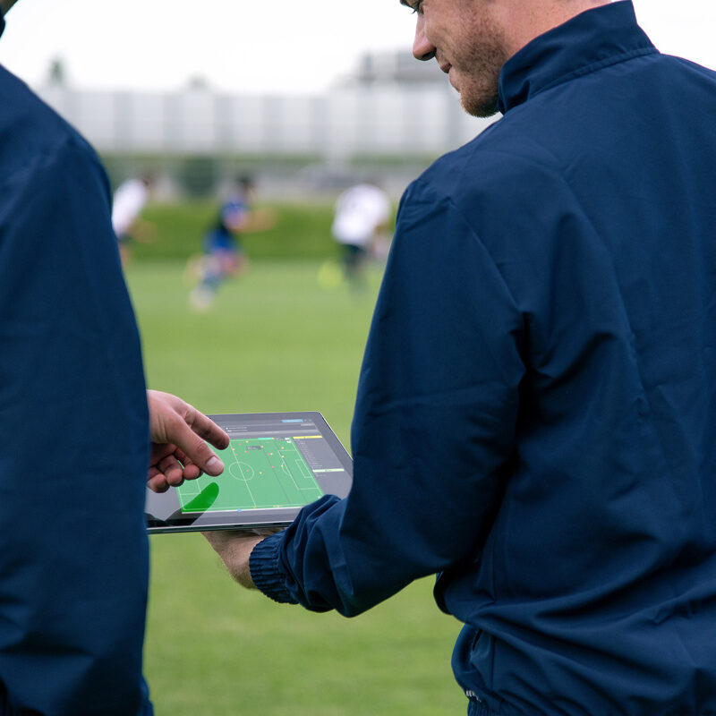 Player tracking data is monitored by sports scientists during a training session.