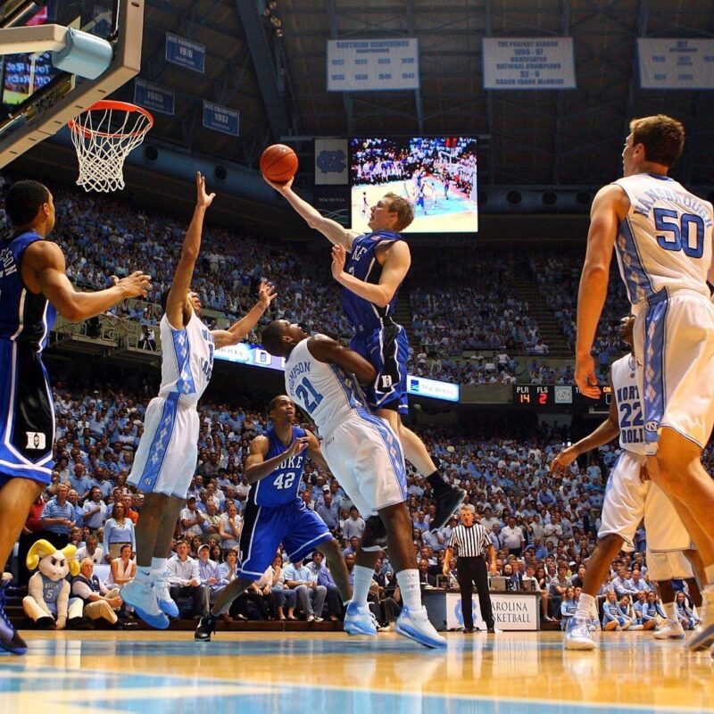 Basketball offense scene with players and ball in stadium